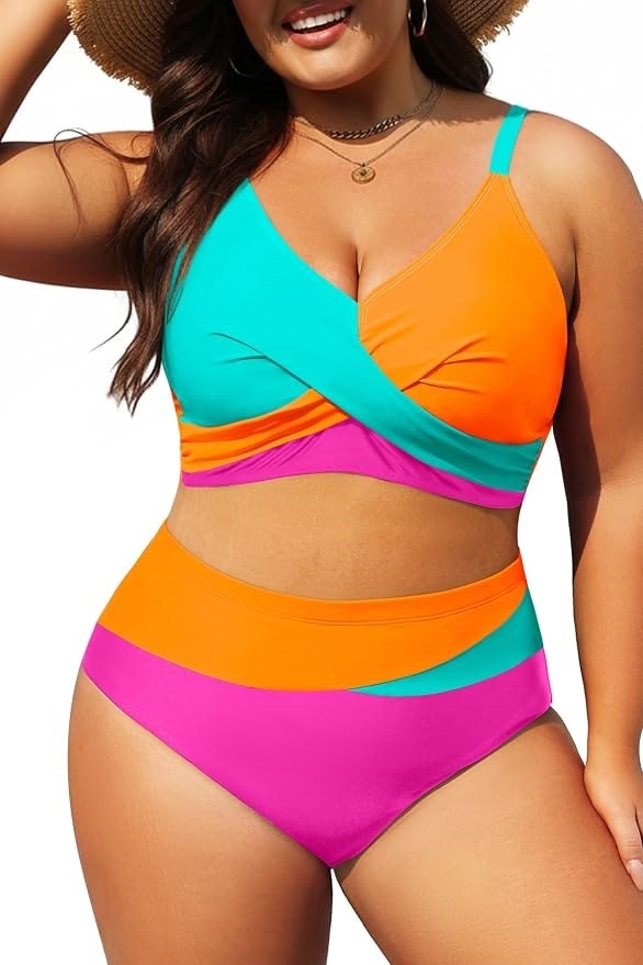 Plus size swimsuits featuring a vibrant color-block bikini with a turquoise and orange twist-front top and pink high-waisted bottoms.