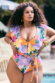 Plus size swimsuits featuring a colorful floral one-piece with a ruffled neckline
