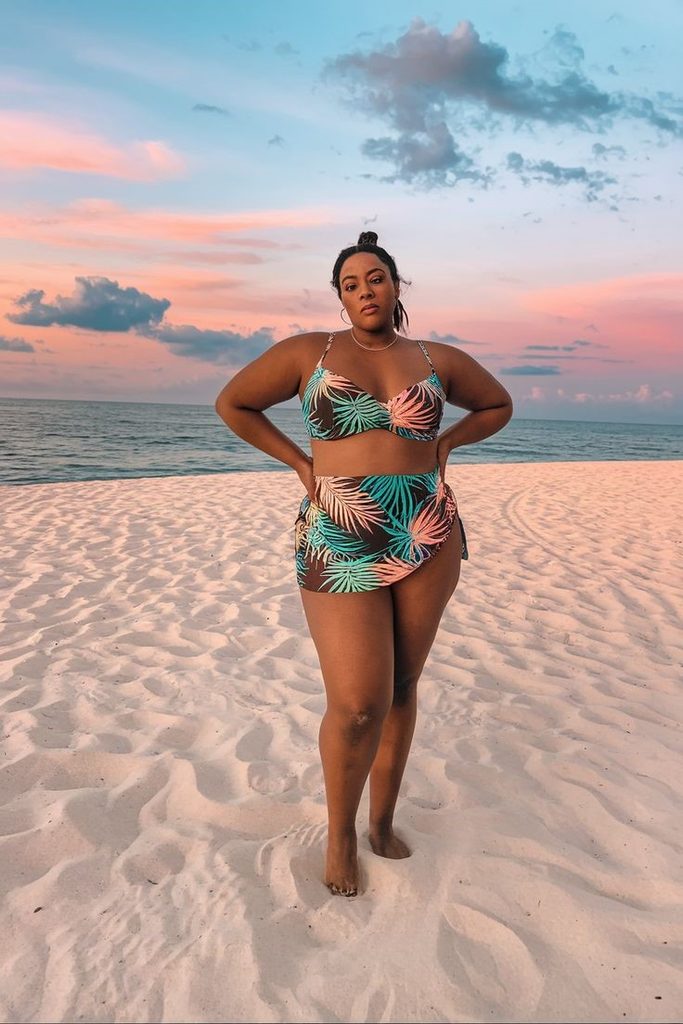Plus size swimsuits with a tropical leaf-print bikini and matching wrap skirt on the beach