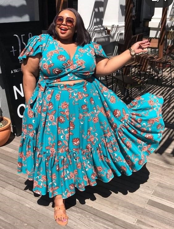 Plus size woman confidently enjoying a floral dress while exploring how to tell if you're wearing the wrong size