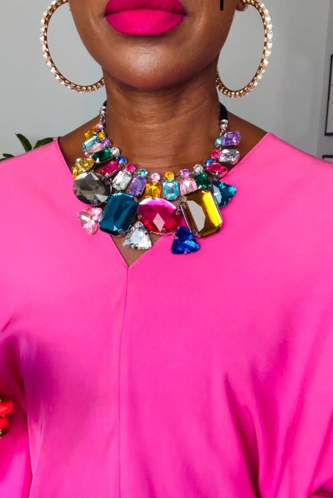 Statement Necklace Styling Guide showing a colorful jeweled necklace styled with a bright pink neckline