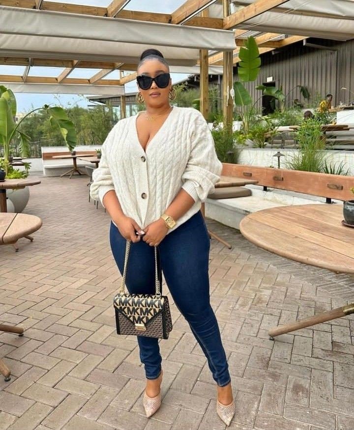 Plus size woman wearing a roomy cardigan and slim jeans showing why your outfits feel off