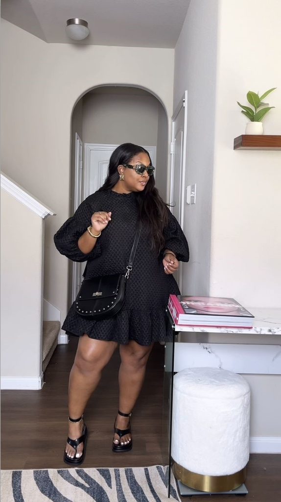 Plus size woman wearing a textured black dress showing why your outfits feel off
